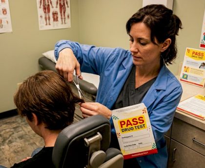 Lab technician cutting hair sample for test
