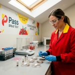 Lab technician examining hair samples in lab