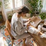 Person organizing detox kit components on table