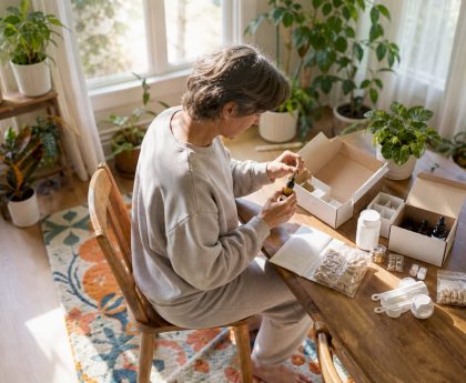 Person organizing detox kit components on table