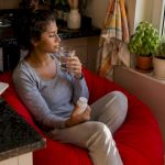 Woman managing detox side effects at home