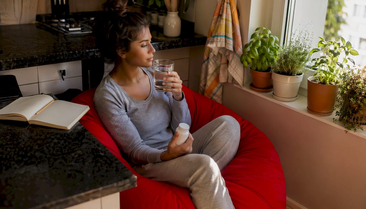 Woman managing detox side effects at home