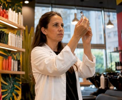 Lab technician inspecting shampoo sample in laboratory