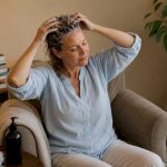 Woman applying detox shampoo to hair roots