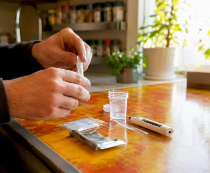 Hands preparing synthetic urine kit