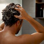 Applying detox shampoo to hair roots