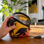 Hand holding insulated pouch with urine cup