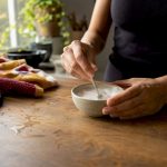 Hands mixing baking soda hair treatment paste
