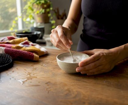 Hands mixing baking soda hair treatment paste