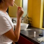 Person collecting saliva sample with swab