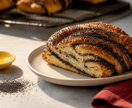 Poppy seeds beside a baked pastry