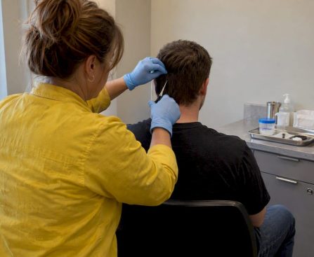 Professional collecting a hair drug test sample