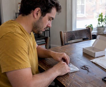 Person sealing a home hair sample kit