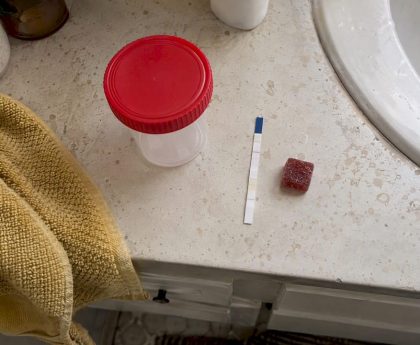 Cannabis gummy beside a urine test strip