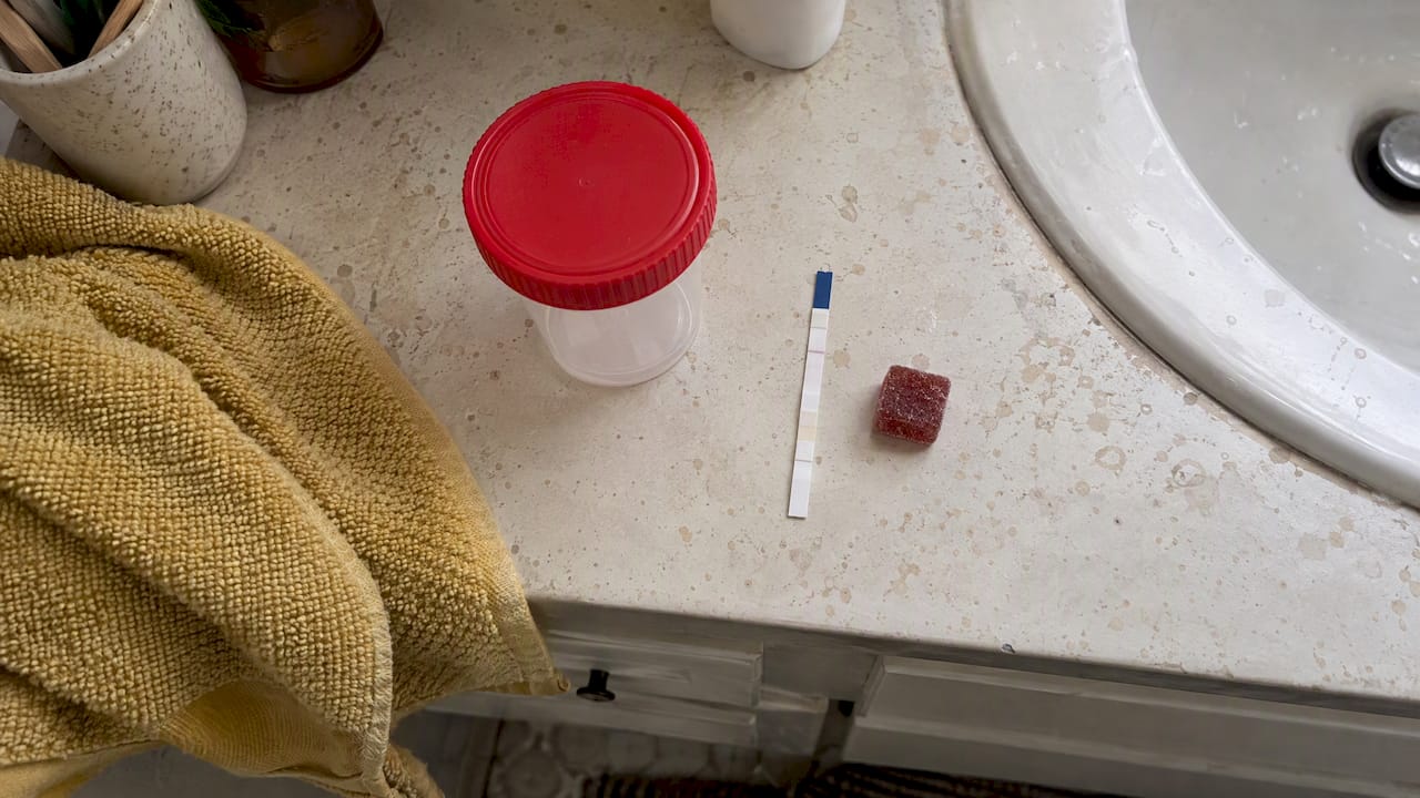 Cannabis gummy beside a urine test strip