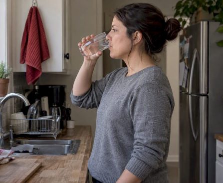 Woman drinks water before urine test