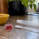Edible gummy beside an oral-fluid swab