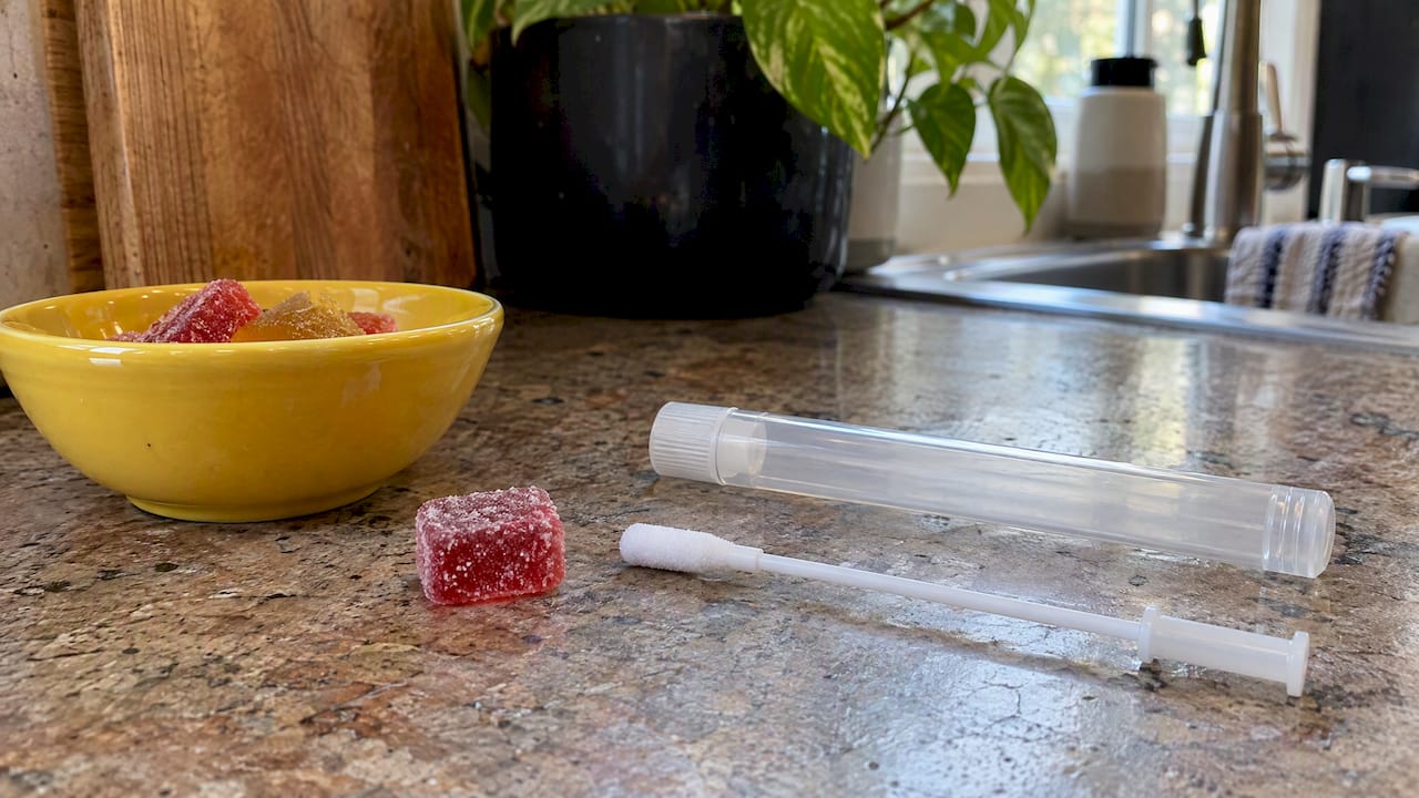 Edible gummy beside an oral-fluid swab