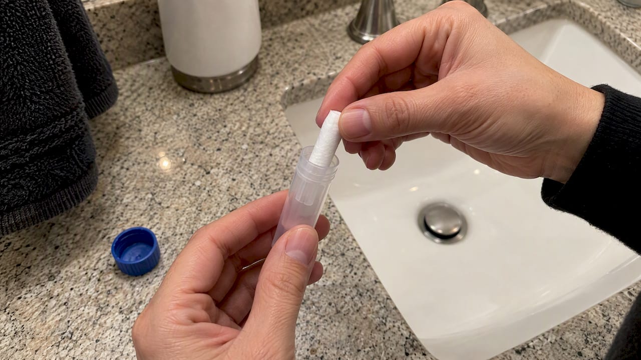 Cotton collection pad being returned to its tube